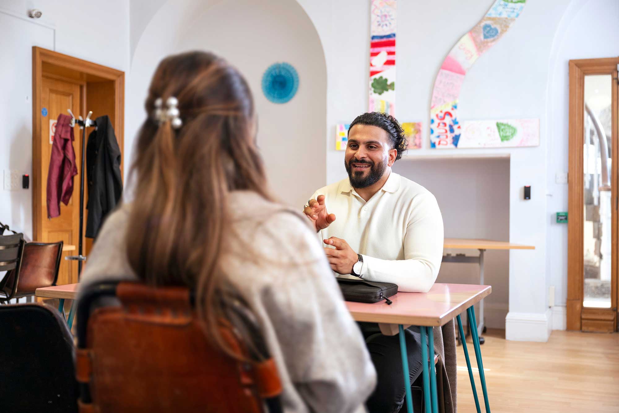 Man talking to woman across a table