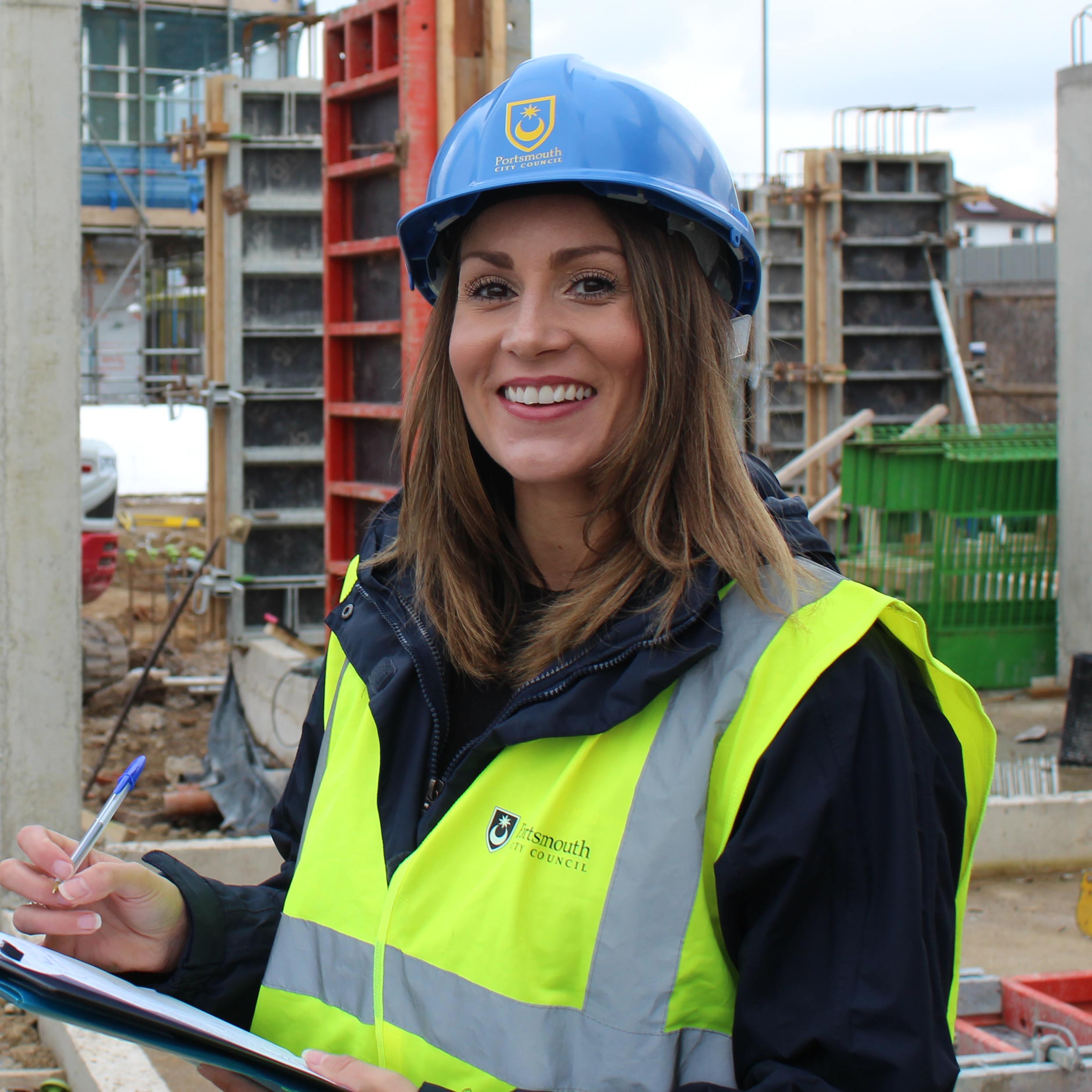 Female engineer in safety attire on a building site