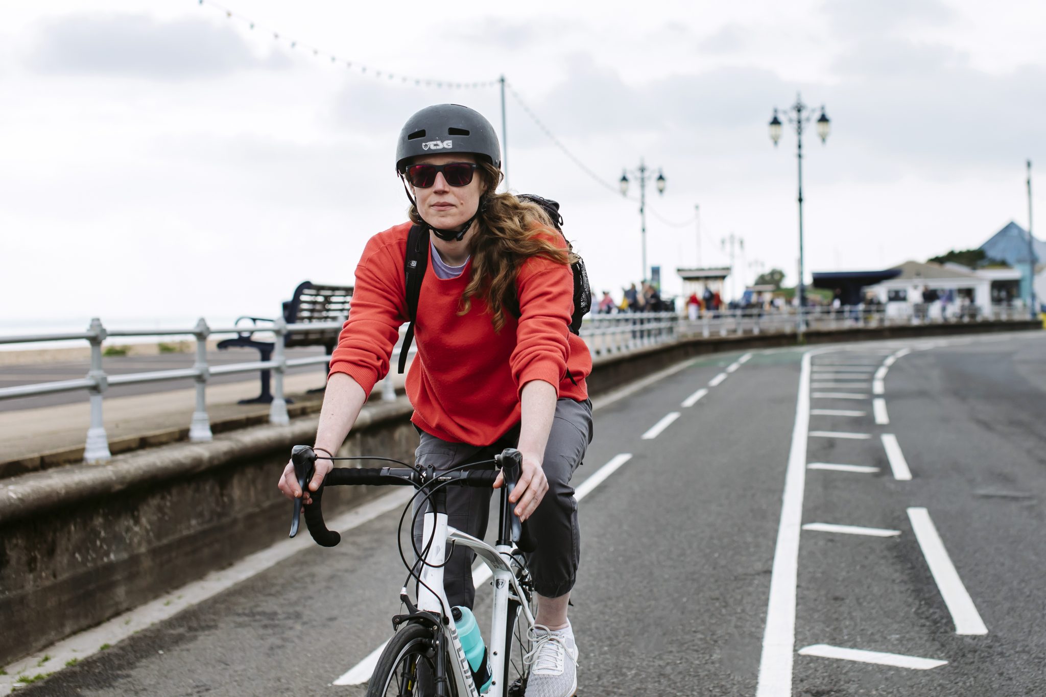 Woman cycling through Southsea seafront