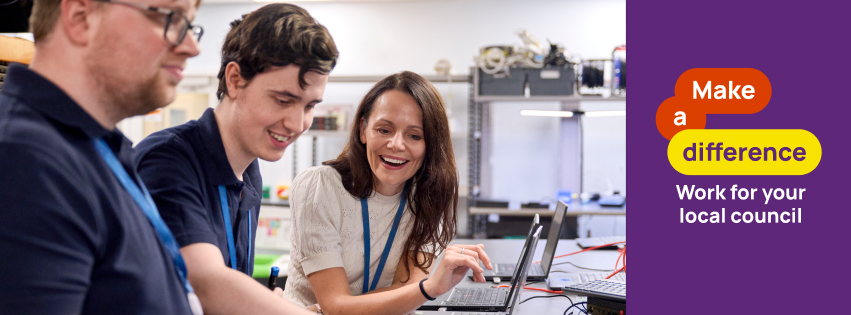 Men and women discussing over a laptop